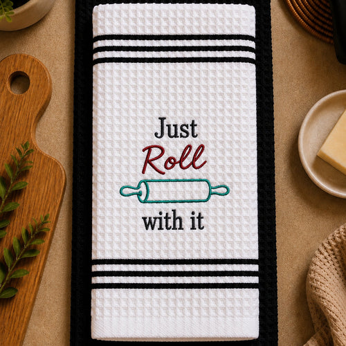 Embroidered kitchen towel set with "Just Roll With It" design by PressMark Studio, featuring colorful, soft cotton towels.