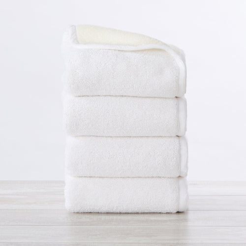 4 Pack Two-Toned Hand Towels from Vanessa Collection hanging in bathroom with modern two-tone design