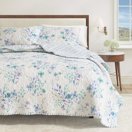 Blue floral April Morning quilt set with matching shams and reversible design
