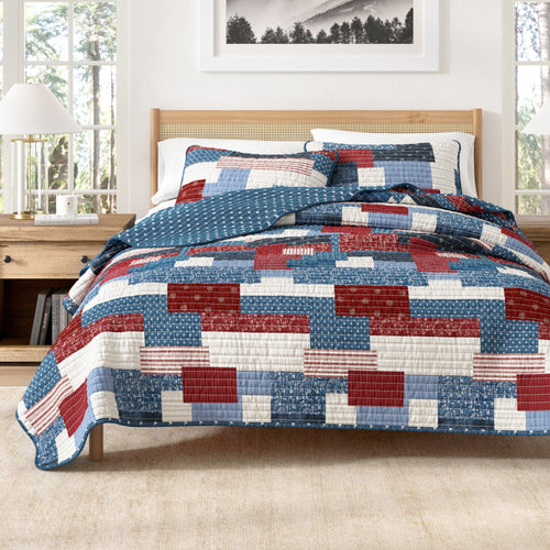Americana Patchwork Quilt Set with patriotic colors and nostalgic design on bed